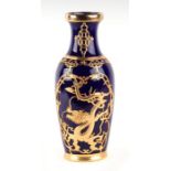 A Chinese monochrome blue vase with gilt metal overlaid decoration, 26cms high.