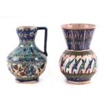 An Iznik pottery handled baluster vase with blue & white floral decoration, 13cms high; together