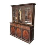 A 19th century mahogany library bookcase on cupboard, the upper section with moulded cornice above