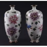 A pair of Japanese cloisonne vases decorated with flowers on a pale grey ground, 15cms high (2).