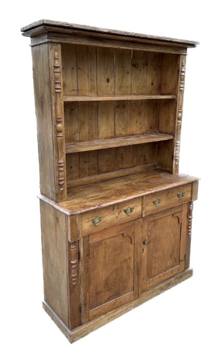 A 19th century stripped pine cottage dresser, the plate rack with a pair of glazed doors enclosing a