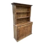 A 19th century stripped pine cottage dresser, the plate rack with a pair of glazed doors enclosing a