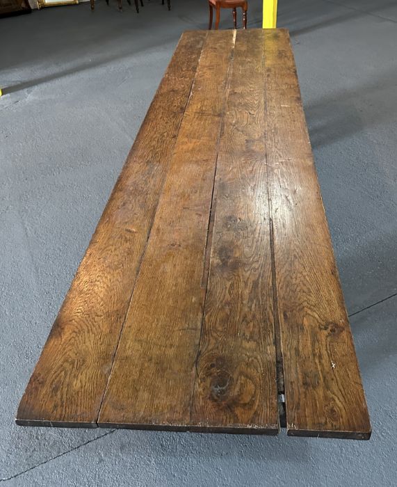 A large 17th century style oak refectory table with four plank top, on trestle supports joined by - Image 4 of 20