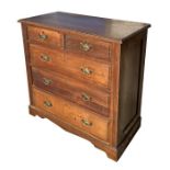 An Edwardian walnut chest of drawers with two short and three graduated long drawers, on a shaped