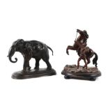 A bronzed spelter in the form of a walking elephant, 18cms high; together with a Victorian spelter