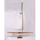 An early 20th century scratch built ten rater wooden pond yacht with rigging and sails, on stand,