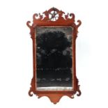 A George III fretwork mahogany wall mirror surmounted by a Ho Ho bird, overall 50 by 93cms.