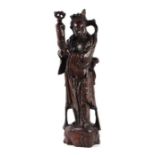 A Chinese carved hardwood figure depicting a wise man holding an urn, with silver wire inlaid