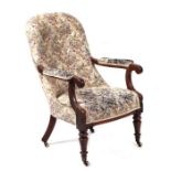 A Victorian mahogany upholstered open armchair on turned front legs.