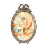 A portrait miniature on celluloid in a bow top frame depicting a naked lady bathing in a river,