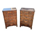 A pair of George III style mahogany chests, each with an arrangement of five long drawers, on