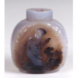 A Chinese banded agate snuff bottle carved with a figure of a man and deer to one face and a house