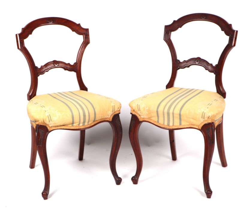 A pair of Victorian mahogany balloon back dining chairs with overstuffed seats (2).