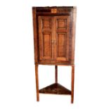 A George III oak hanging corner cupboard with mahogany crossbanding and boxwood inlaid decoration,