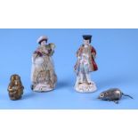 A group of novelty tape measures to include two figural porcelain figures; a brass monkey and a