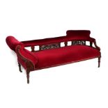 A late Victorian / Edwardian walnut chaise longue with upholstered back rail and seat, on turned