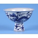 A Chinese blue & white stem bowl decorated with dragons amongst clouds, four character blue mark