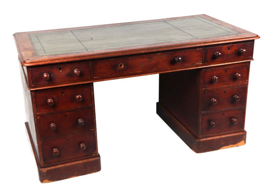 A late Victorian mahogany pedestal desk, the rectangular leather inset top above three frieze