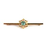 An Edwardian 15ct gold seed pearl and aquamarine type stone bar brooch, 2.8g.