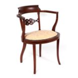 An Edwardian inlaid mahogany occasional chair with upholstered seat.