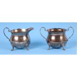 A modern sterling silver cream jug with scroll handle and hoof feet and a matching sucrier, 342g (