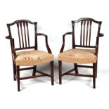 A pair of late 19th century open armchairs with carved spindle backs, overstuffed seats, scroll arms