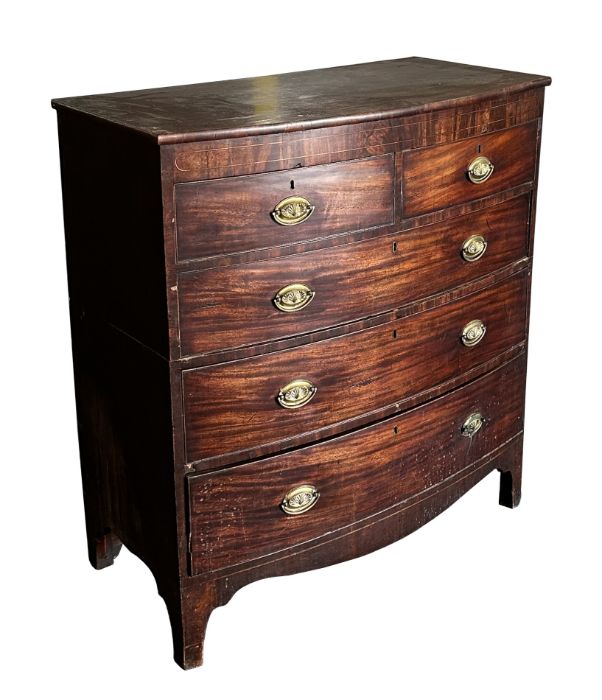 A George III mahogany bowfront chest of drawers with two short and three graduated long drawers,