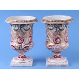 A pair of 19th century Derby urns decorated with foliate scrolls with gilt highlights, 19cms high (