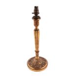 A carved giltwood table lamp with tapered reeded column and acanthus leaf carved finial and base,