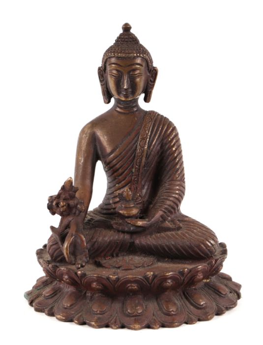 A cast bronze figure of Buddha seated within a lotus flower, 15cms wide.