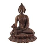 A cast bronze figure of Buddha seated within a lotus flower, 15cms wide.