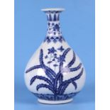 A Chinese blue & white vase decorated with flowers and foliage, 25cms high.