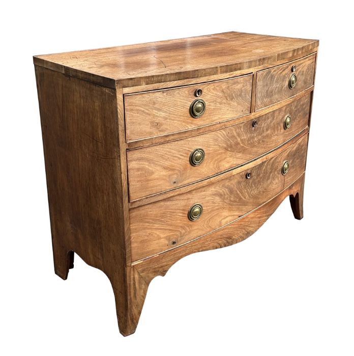 A George III mahogany bowfront chest of drawers with an arrangement of two short and two graduated