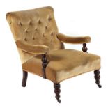 A Victorian upholstered button back open armchair on ring turned front legs.