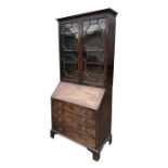 A George III mahogany bureau bookcase, the upper section with twin astragal glazed doors enclosing