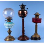 Two Victorian oil lamps; together with a copper oil lamp on a mahogany stand (all a/f) (3).Condition