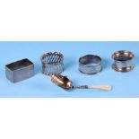 Four silver napkin rings, various dates and makers; together with a sugar shovel with mother of