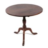 A 19th century oak tilt-top tripod table with turned column, on triform base with slipper feet,