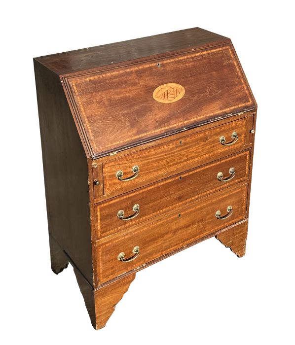 An Edwardian mahogany bureau, the fall-front with shell inlay revealing a fitted interior above