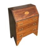 An Edwardian mahogany bureau, the fall-front with shell inlay revealing a fitted interior above