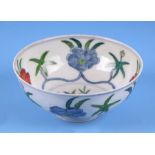 A Chinese Wucai style footed bowl decorated with flowers, six character blue mark to the