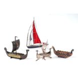 A Danish silver (marked 830) Viking longboat, 104g, 15cms long; together with two other ceramic