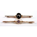 A 9ct gold bar brooch set with a garnet cabochon and seed pearls together with another set with an