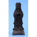 A Chinese bronzed metal figure of a robed man holding a sceptre, 25cms high.