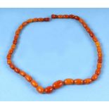 A butterscotch amber graduated bead necklace, 15g, the largest bead 17mm.