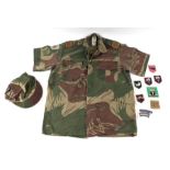 A Rhodesian BSAP Reserve camouflage uniform and various Rhodesia Army cloth badges.Condition