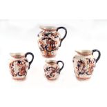 A harlequin set of four graduated jugs decorated in the Imari palate, the largest 19cms high (4).