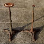 A pair of cast iron garden table bases, 68cms high (2).