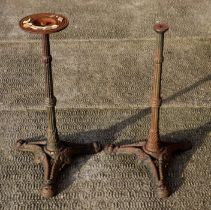A pair of cast iron garden table bases, 68cms high (2).