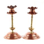 A pair of Arts & Crafts copper and brass candlesticks in the manner of Dr Christopher Dresser, 18cms
